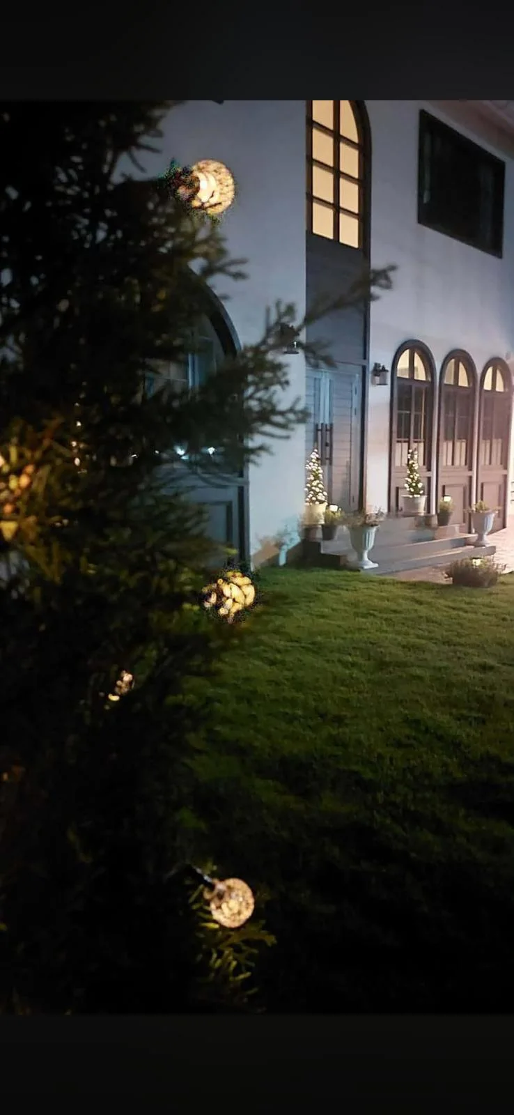 Property exterior at dusk with warm lights visible.
