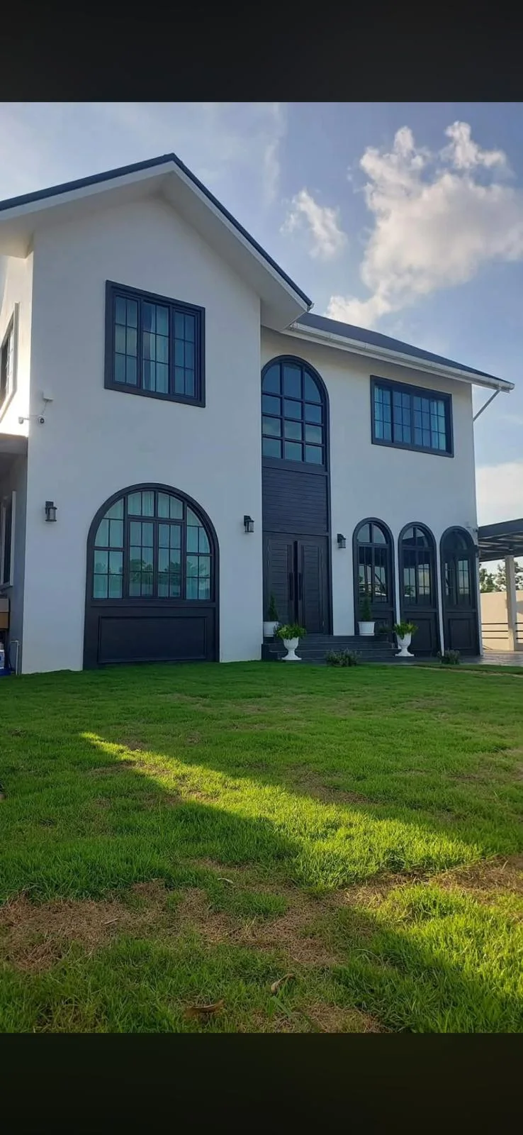 Front exterior of the property and lawn in daylight.